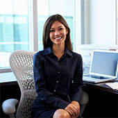 Portrait of a businesswoman at a desk with laptop, files and coffee